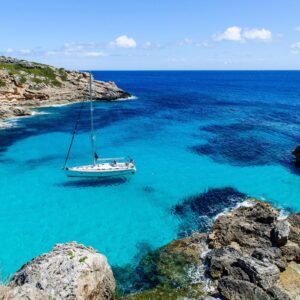 Sailing boat at anchor. Paradise wild bay. Cala Marmolis.